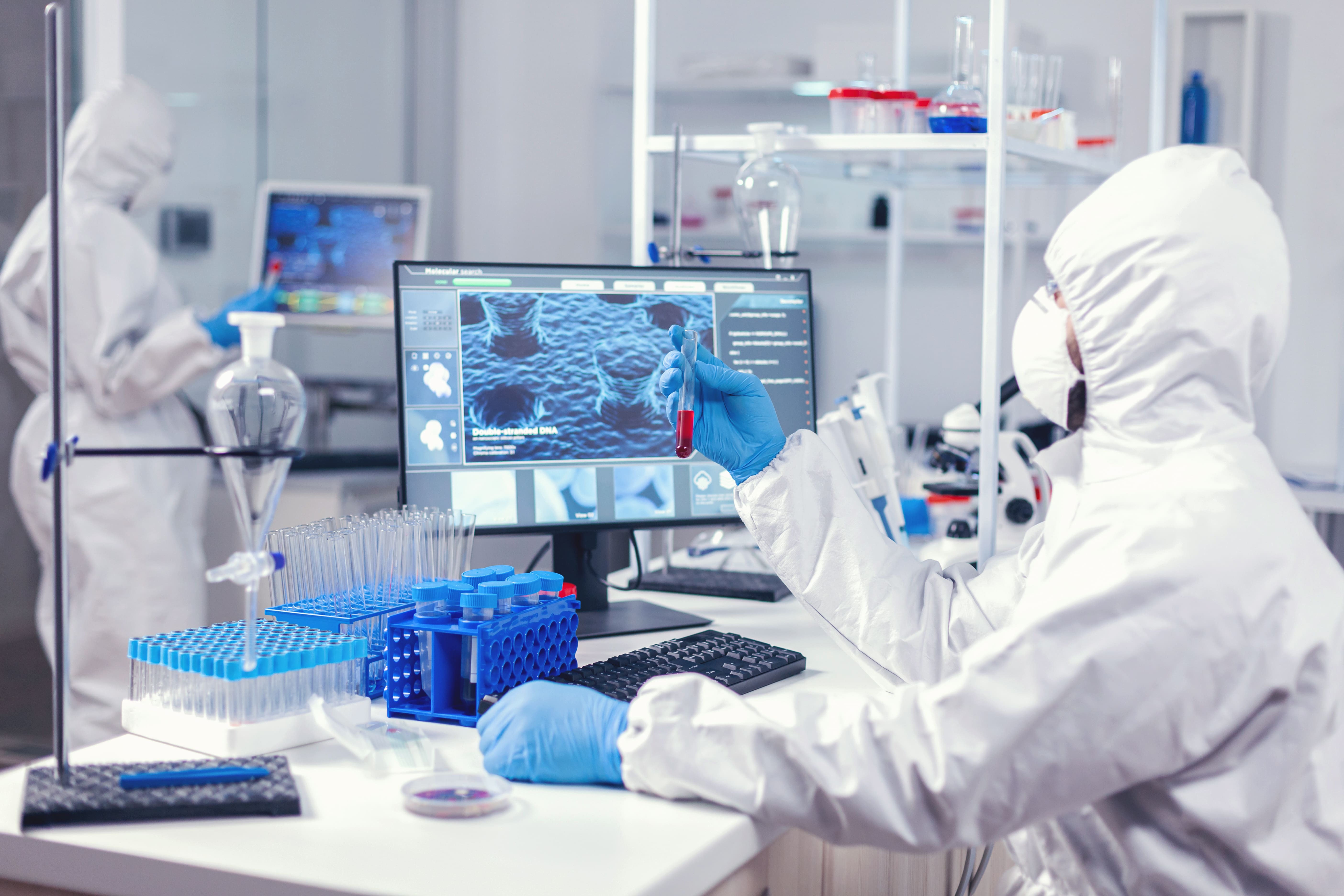 Blue gloves and test tube